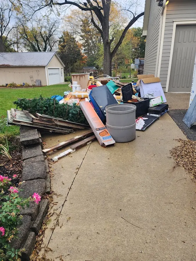 Dumpster being loaded with debris for 12 Yard Dumpster Rental in Berkeley Heights